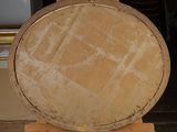 a wooden easel that has a large round object on it