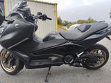 a picture of a black motorcycle parked in front of a building