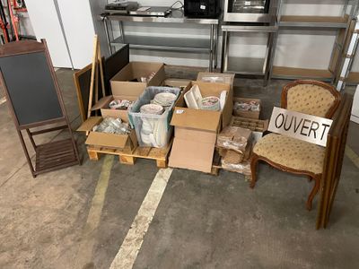 a pile of boxes and chairs in a garage