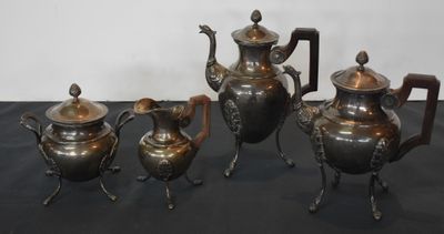 three silver teapots and a tea pot on a table