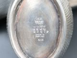 a close up of a silver plate with a clock on it