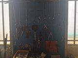 many tools hanging on the wall in the room