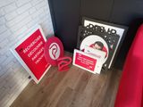 a red chair next to a red sign and a red chair