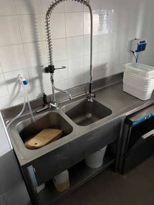 two sinks in the kitchen with two faucets on the counter