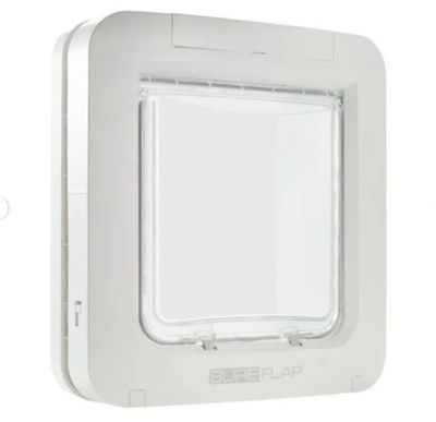 a close up of a white cat flap door on a white wall