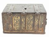 an old metal box with ornate designs on the inside