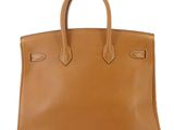 a brown leather handbag on a white background
