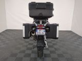 a motorcycle that is parked in a room with a checkered floor
