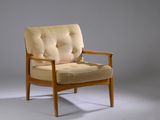 an image of a chair with a cushion on it in front of a gray background