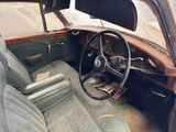 an old car that is sitting in the dirt