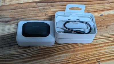 a box with a charger and a cable in it on a wooden table