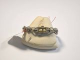 a bracelet that is sitting on top of a white hat
