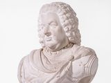 a white bust of a man with curly hair