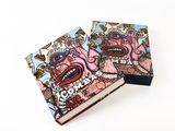 a couple of small notebooks sitting on top of each other