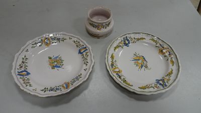 two plates and a cup sitting on a table