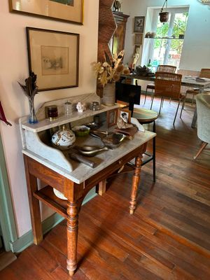 a kitchen with a table and chairs and pictures on the wall
