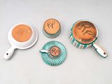 three cups of coffee and a saucer on a table