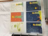 several children ' s books are hanging on a rack in a kitchen