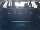 the back of a car with the trunk open and the seats folded down