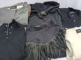 a lot of sweaters that are sitting on a table