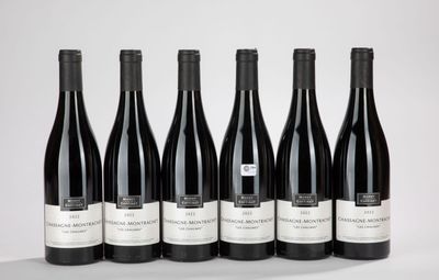 six bottles of wine are lined up in a row on a table