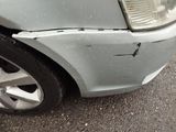 a car that has a dent in the front of it