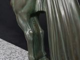 statue of a man and woman kissing on a horse on a marble base
