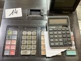 a calculator sitting on top of a desk next to a keyboard