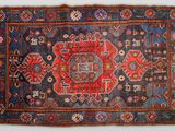 un vieux tapis à motifs rouges et bleus