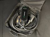 an open suitcase with a hose and a remote in it