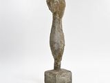 an image of a sculpture of a woman ' s head on top of a stone block