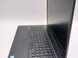 a laptop computer sitting on a table with a keyboard