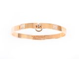 a close up of a gold bracelet on a white background