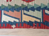 an image of a multicolored rug with holes in it