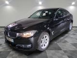 une photo d'une voiture bmw noire dans une salle d'exposition