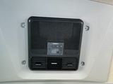 a picture of a small air conditioner mounted on the side of a wall