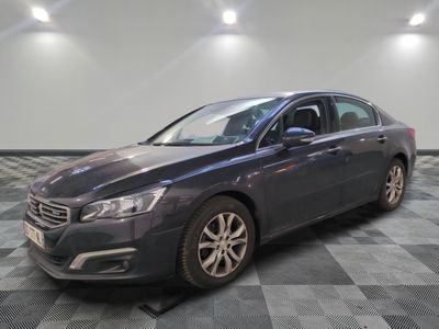 the grey car is parked on a checkered floor in the garage