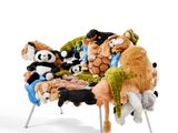 many stuffed animals that are sitting on a chair