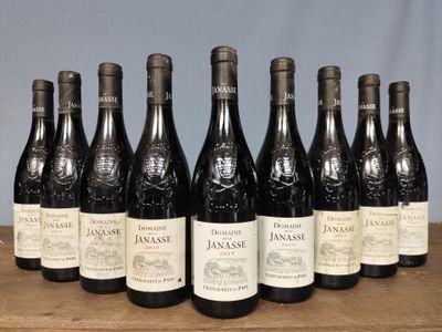 six bottles of wine are lined up on a wooden table