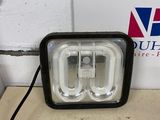 a close up of a light on a table near a sign