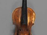 a close up of a violin with a bow on a gray background