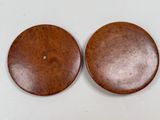 two pieces of wood sitting on top of a white surface