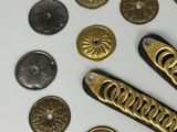 many different types of buttons and a knife on a table