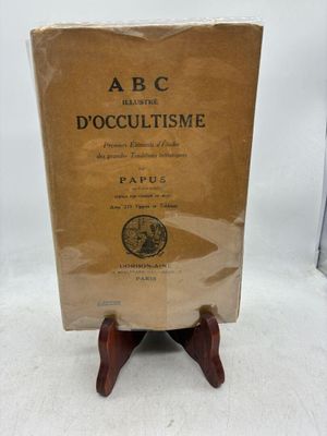 un vieux livre posé sur un support en bois, sur une surface blanche