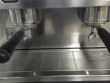 a close up of a coffee machine with two espressors