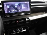 the interior of a car with a touch screen and steering wheel