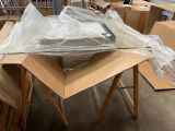 a table with a laptop on top of it in the middle of a pile of boxes