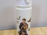 harry potter and hermione water bottle on a wooden table