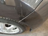 a close up of a car with a denting on the side of it