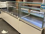 a glass display case in the middle of a store